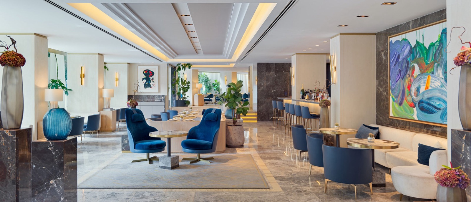 The One Barcelona lobby lounge and bar with blue velvet armchairs and marble floors