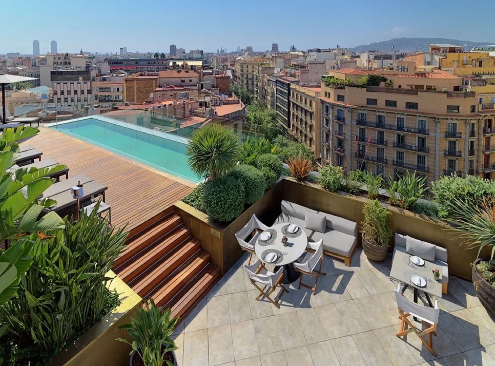 Rooftop infinity pool and terrace with a Barcelona skyline view