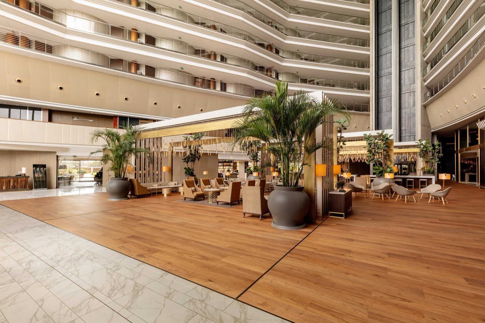 Grand multi-storey hotel atrium lobby with lounge seating