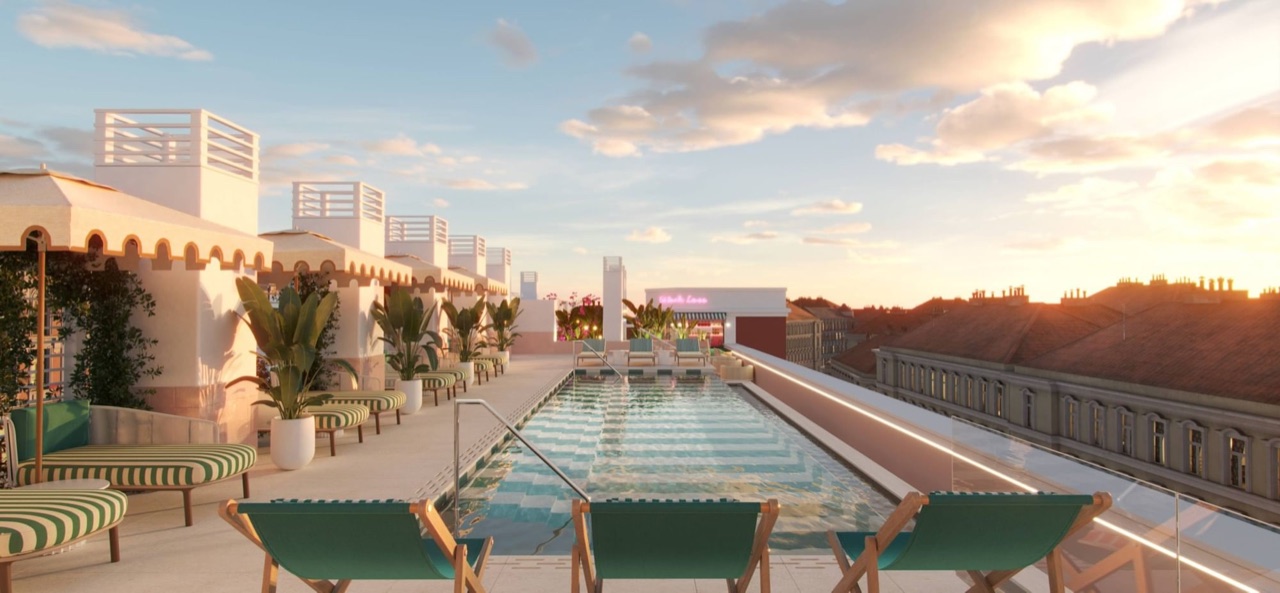 A rooftop infinity pool lined with green striped loungers at dusk, with Madrid's rooftops visible beyond the glass edge.