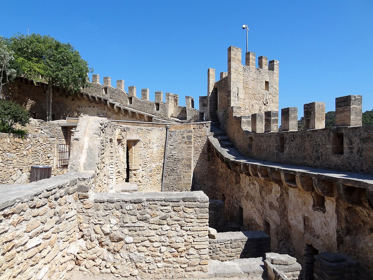 Crenellated stone ramparts and tower of Castell de Capdepera, Mallorca, Spain
