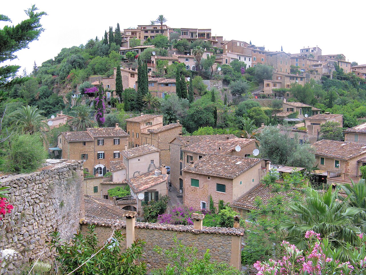 Hillside village of Deià with stone houses among greenery, Mallorca, Spain