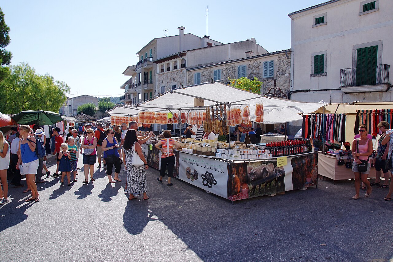 A charcuterie stall with hanging hams at the Sineu Wednesday market