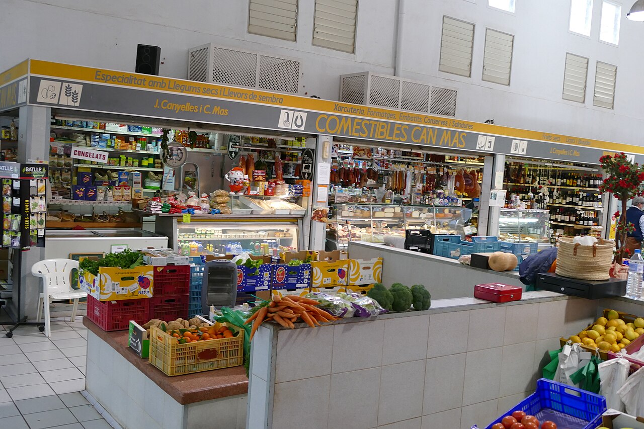 A produce and charcuterie stall inside the Sóller municipal market hall