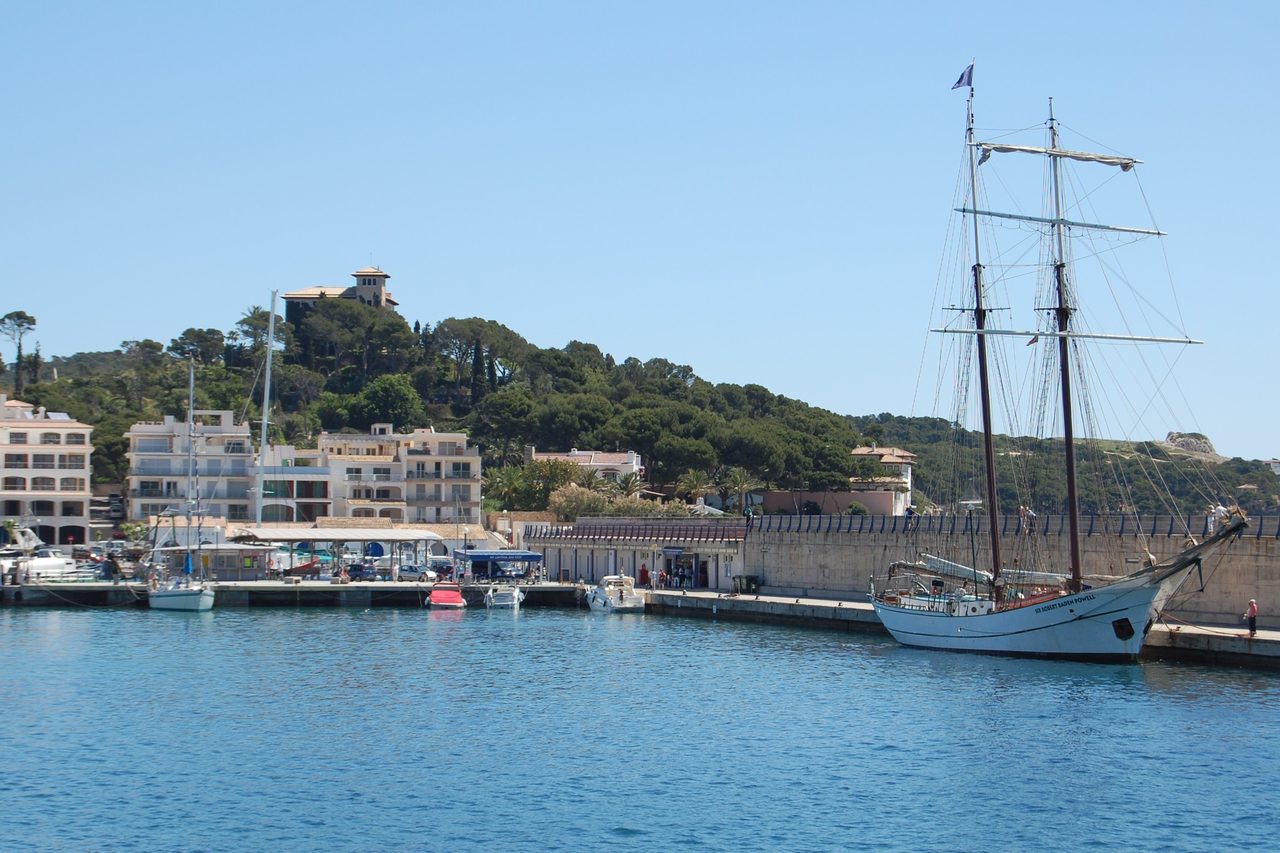 The harbour at Cala Rajada, with moored boats and the waterfront behind