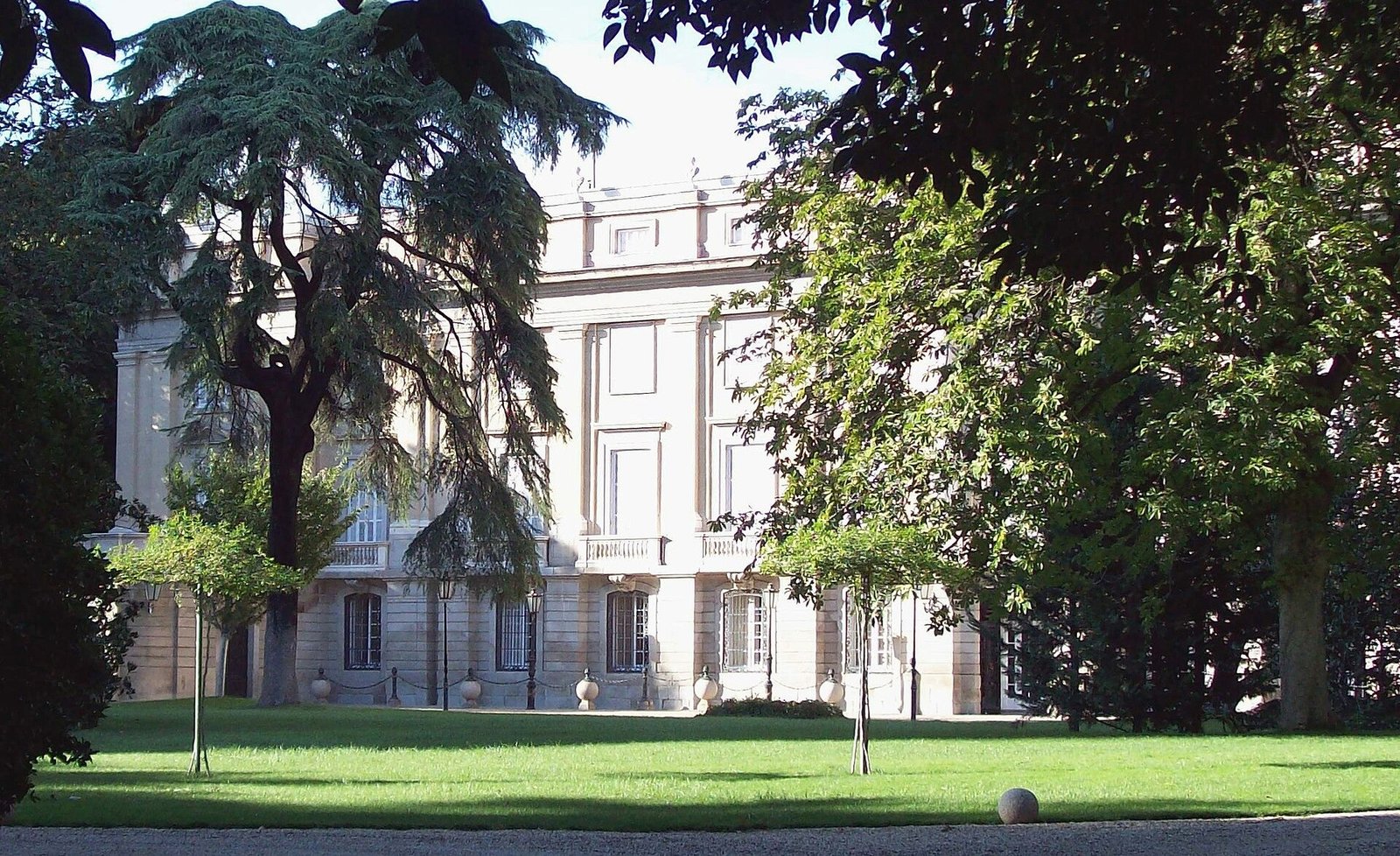 The façade of the Palacio de Liria in Madrid seen across its garden lawn.