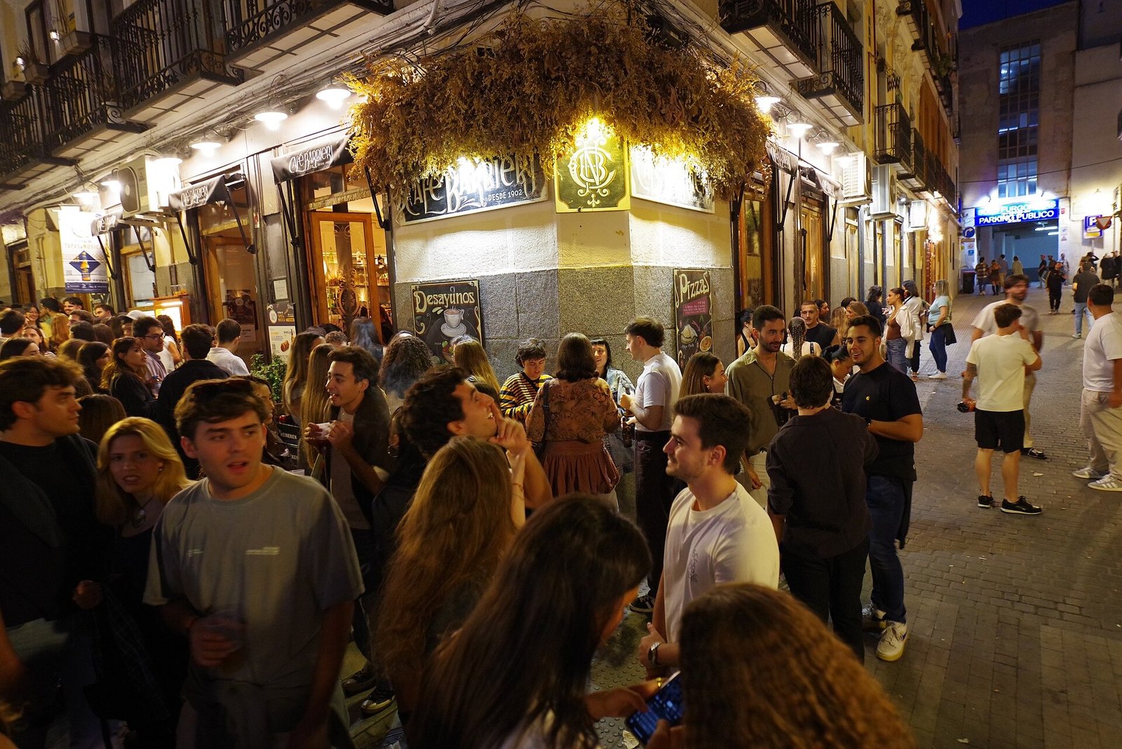 A dense crowd filling Calle del Ave María in Lavapiés at night during Tapapiés 2025.