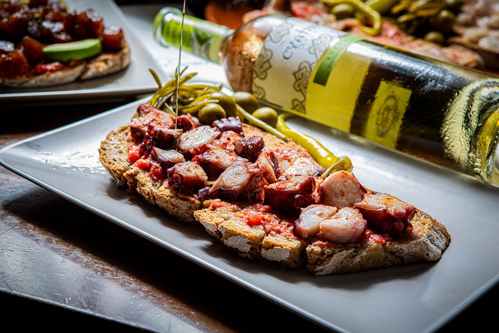 Octopus pa amb oli with olive oil poured tableside