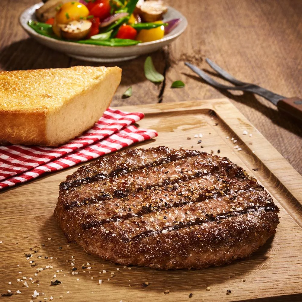 Grilled burger patty with toasted bread and vegetables
