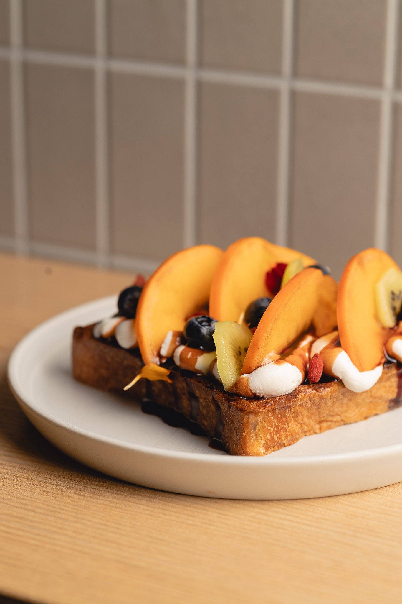 Shibuya toast topped with sliced peach, kiwi and berries