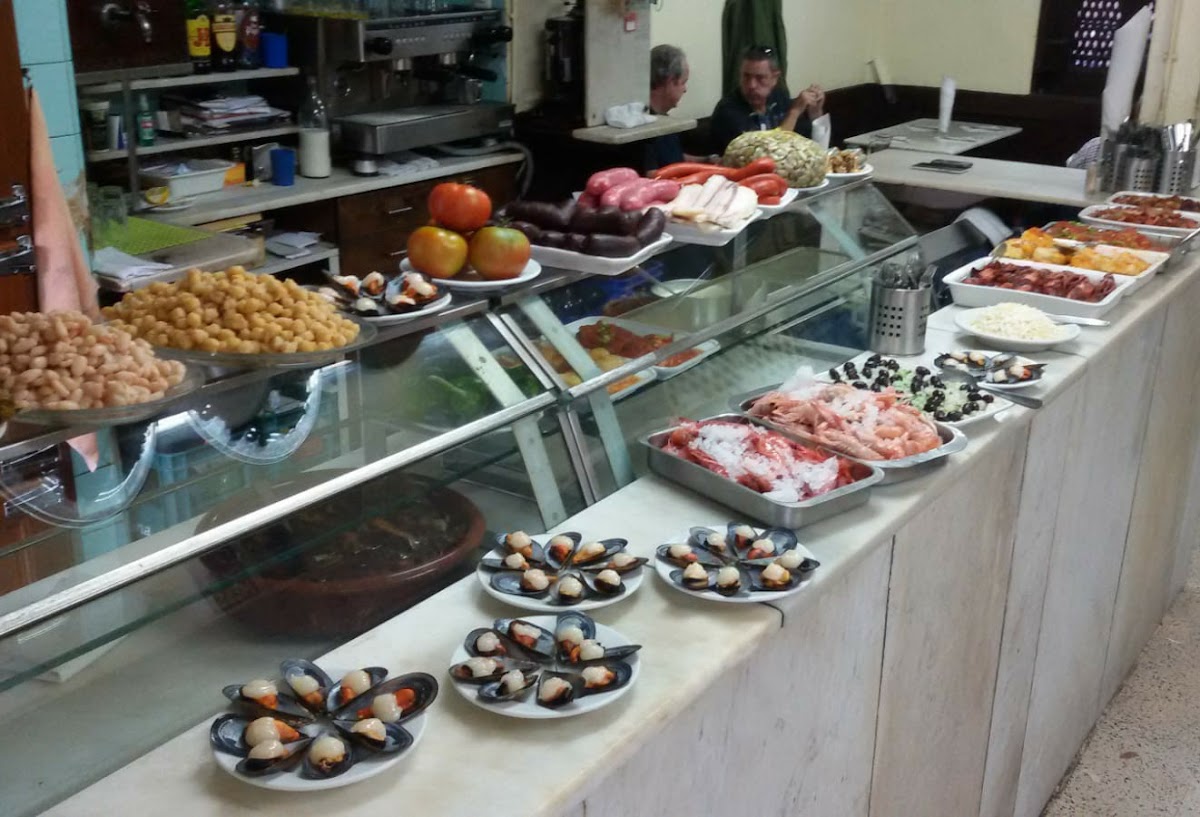 The bar counter at La Cova Fumada with fresh seafood and tapas on display