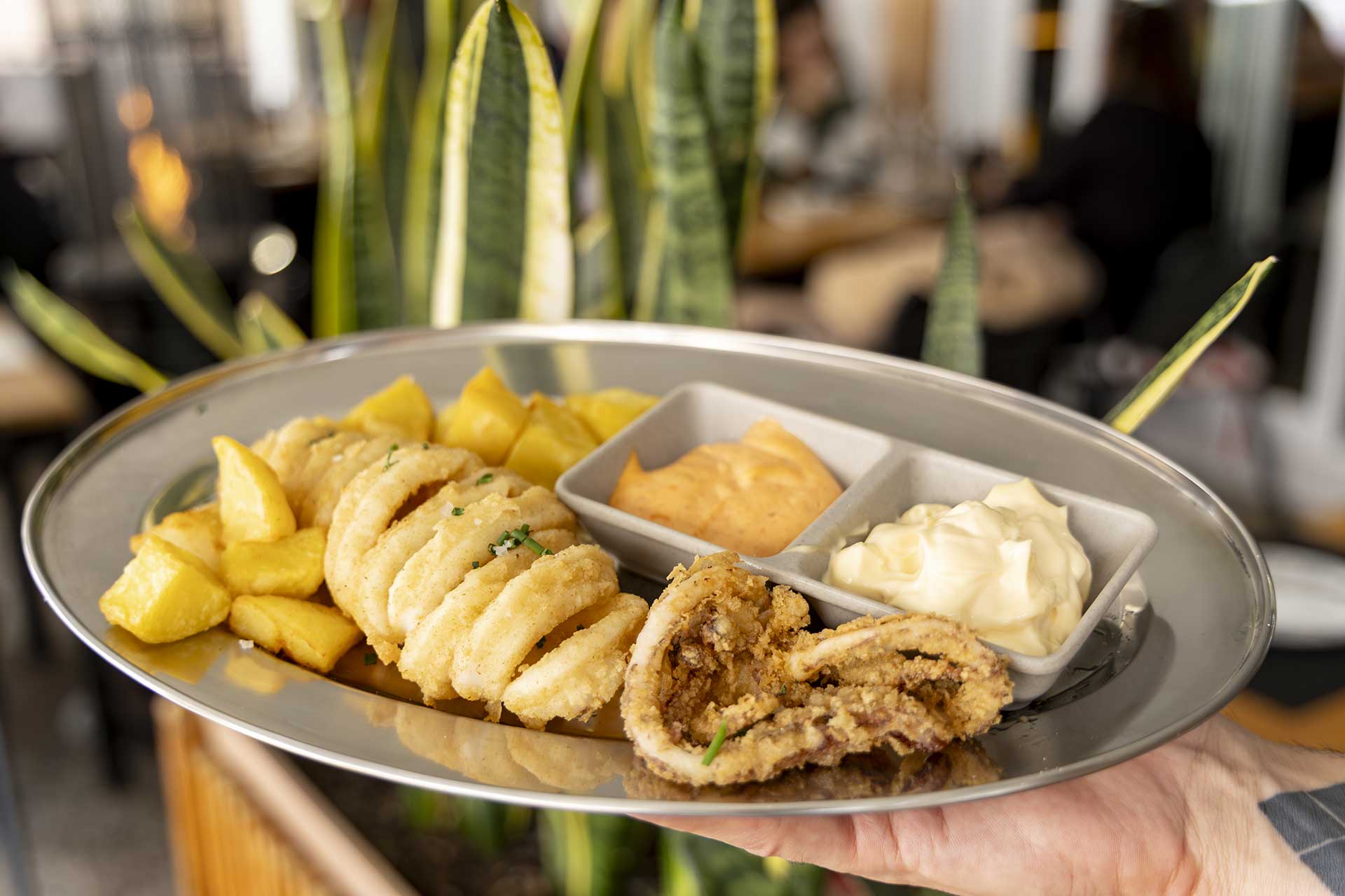 Fried calamari rings with potatoes and two sauces