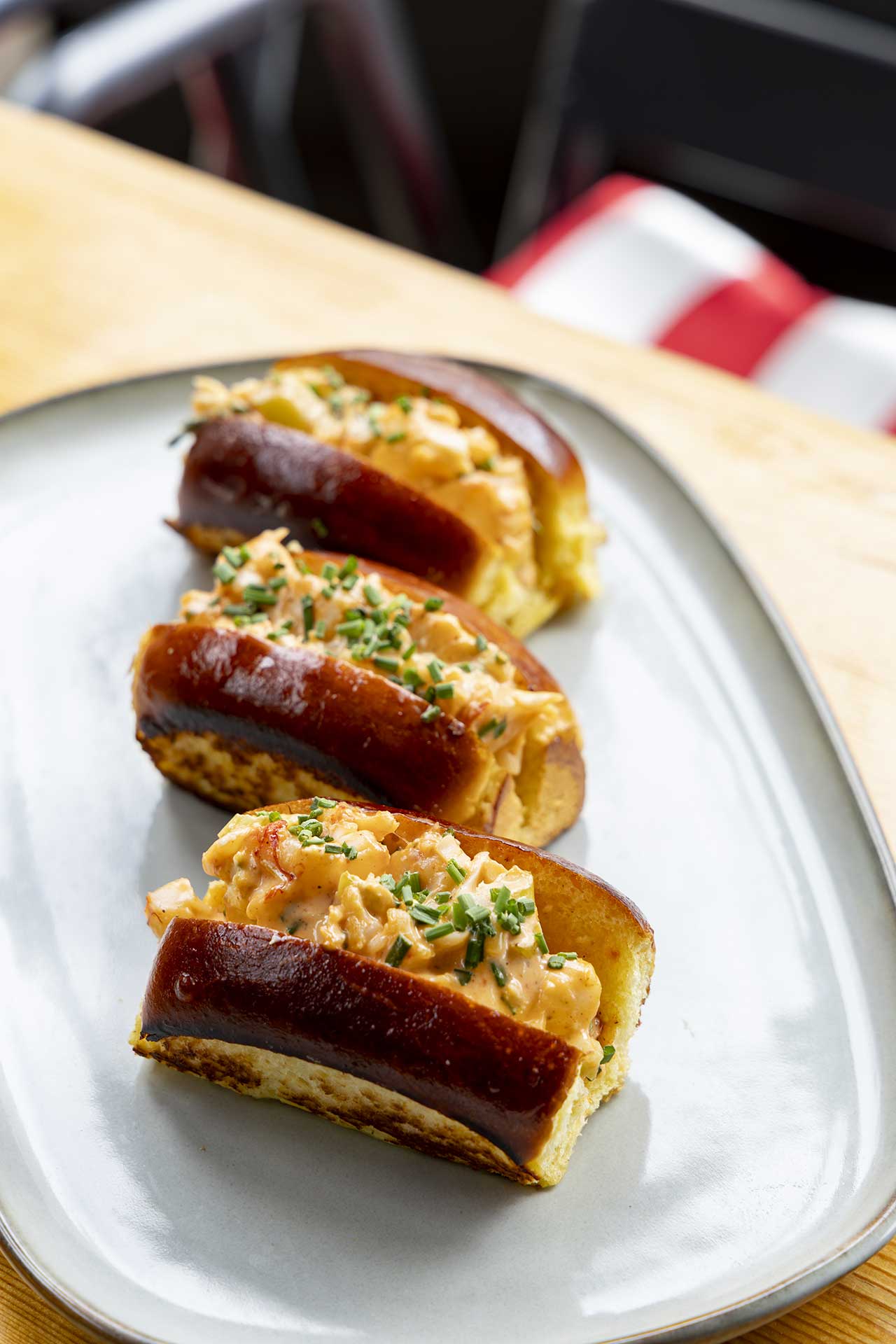 Three brioche pintxos topped with prawn and chives