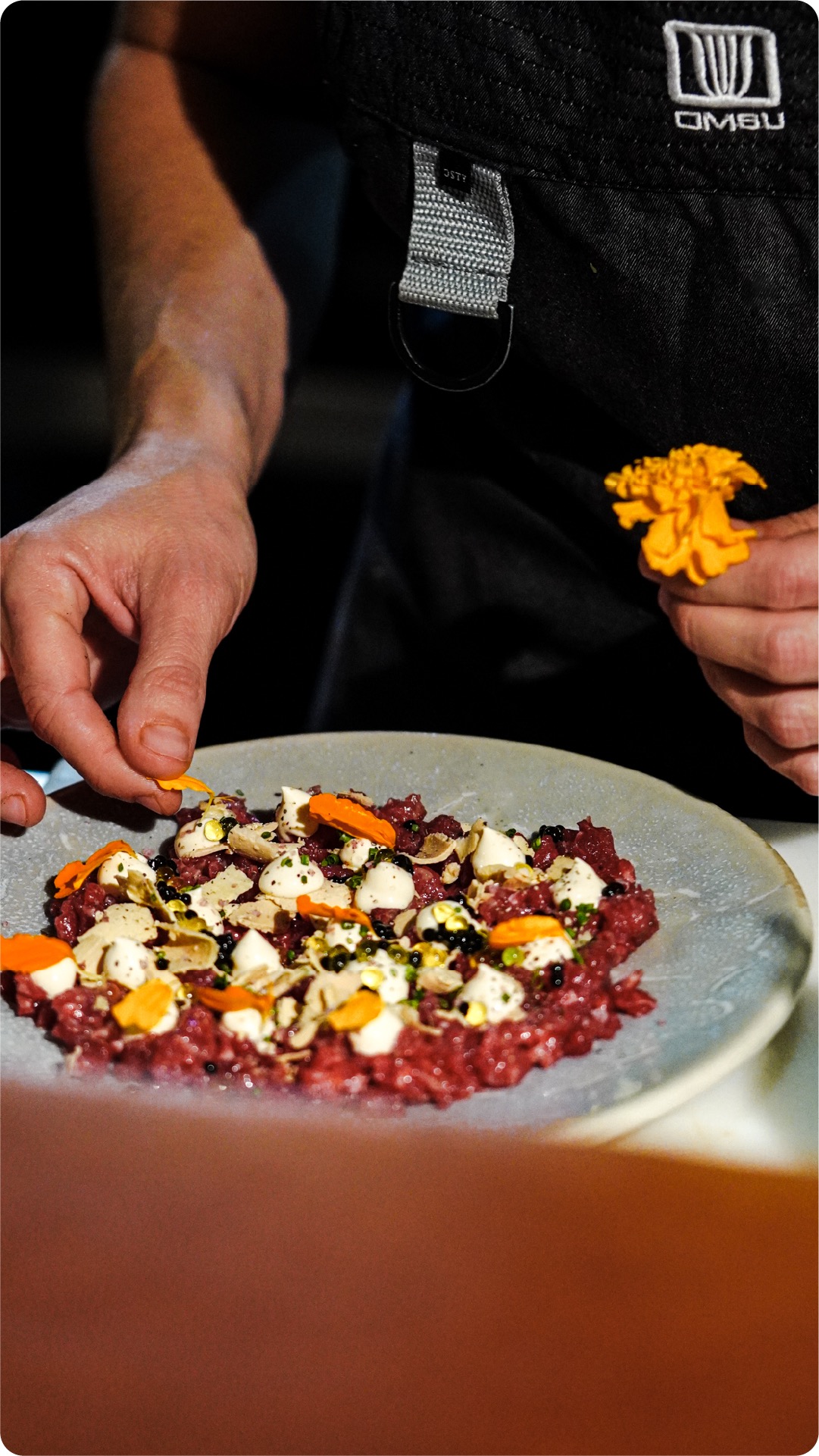 Beef steak tartare with truffle plated with citrus and mozzarella